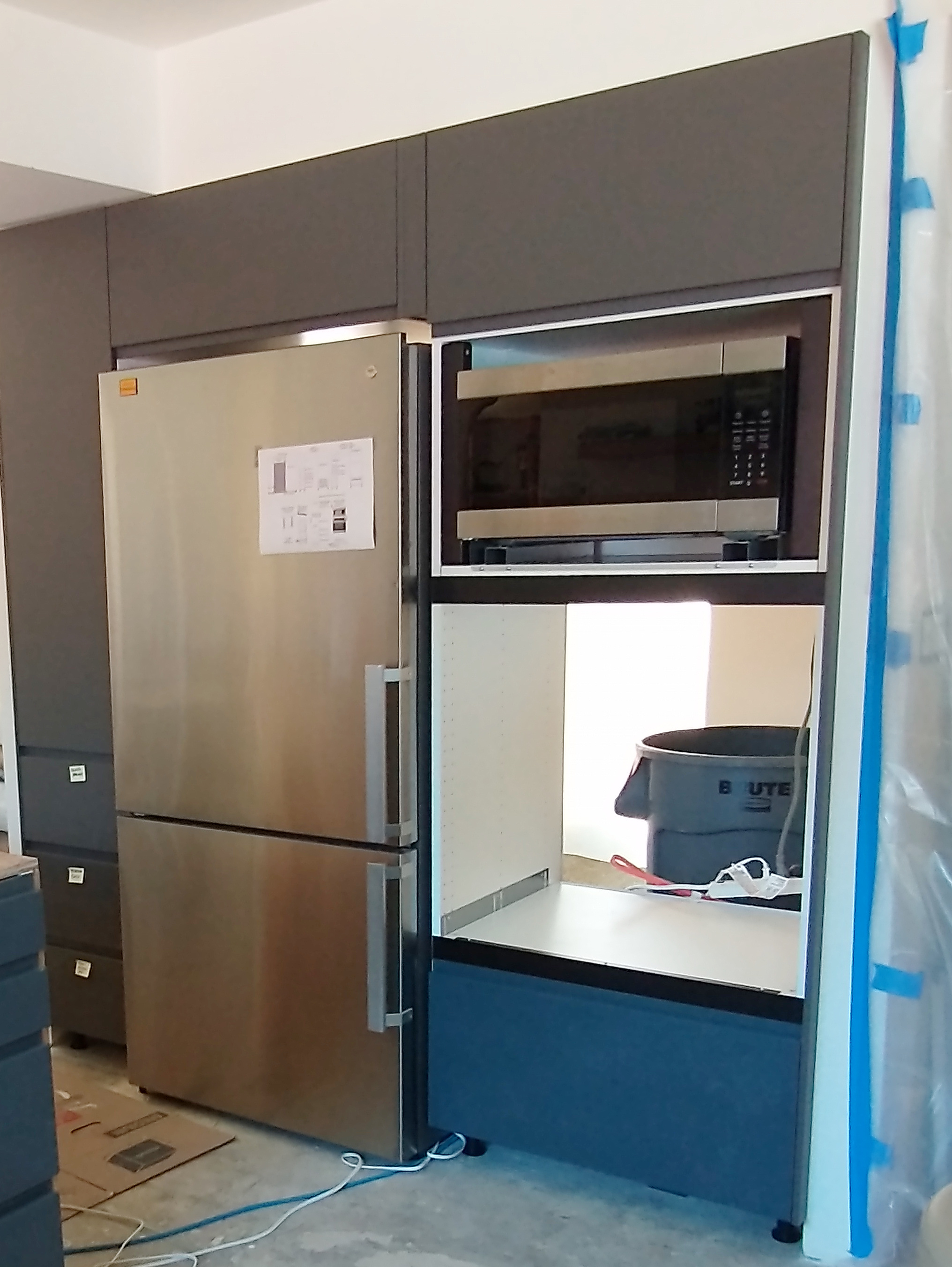 Technician installing a built-in oven in a US kitchen