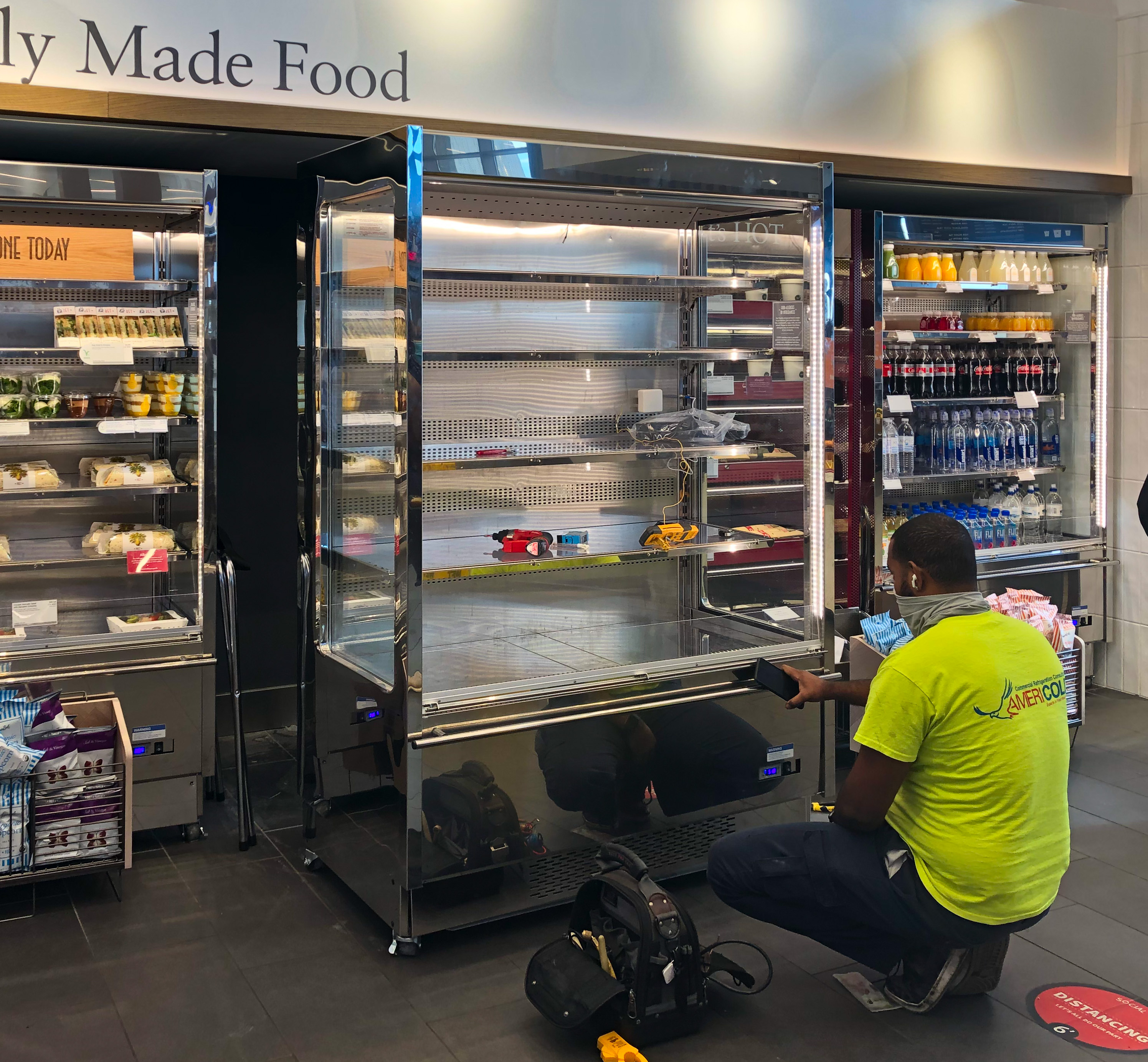 US technician repairing a refrigerator